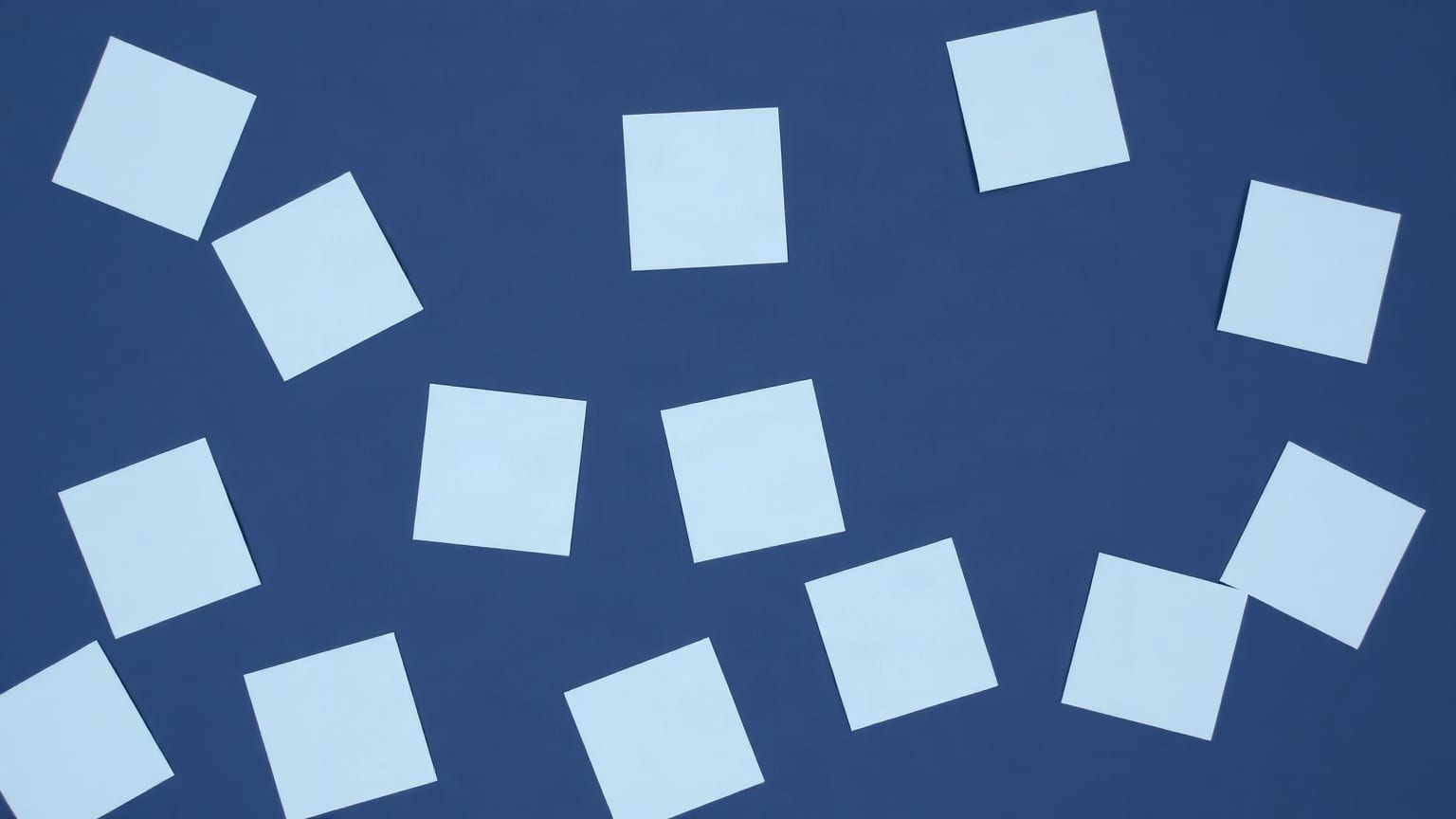 Eleven pale blue paper squares of varying sizes scattered across a deep navy ground, one of them chalk white