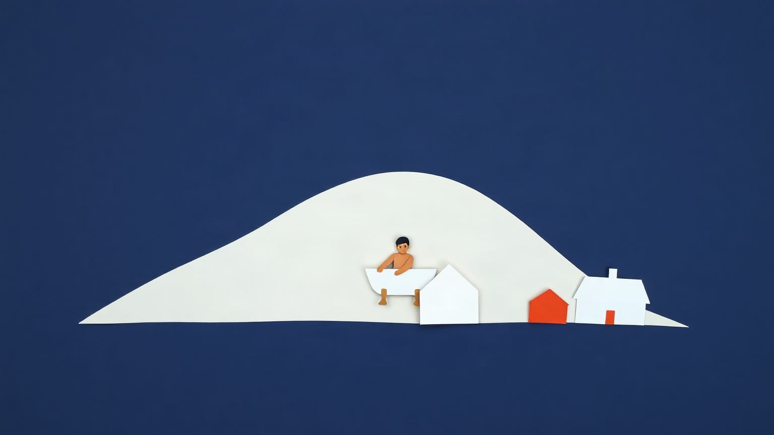 A broad white cut-paper hill filling the frame with a small figure sitting in a white bathtub near its crest and two little houses at the foot, one with a red roof, on a deep navy ground