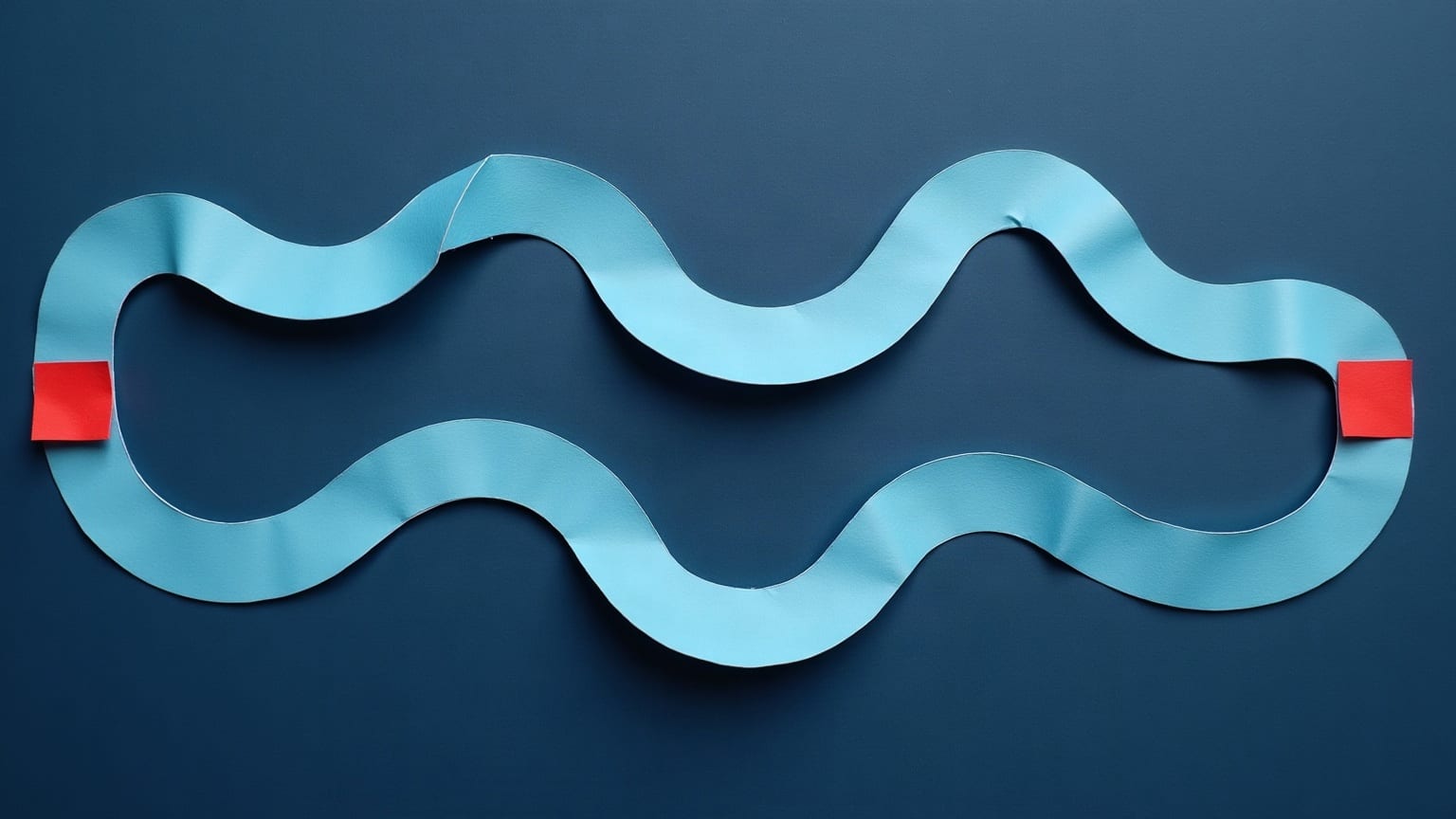 Two pale blue paper ribbons of identical shape laid side by side on a deep navy ground, one small red marker at the end of each